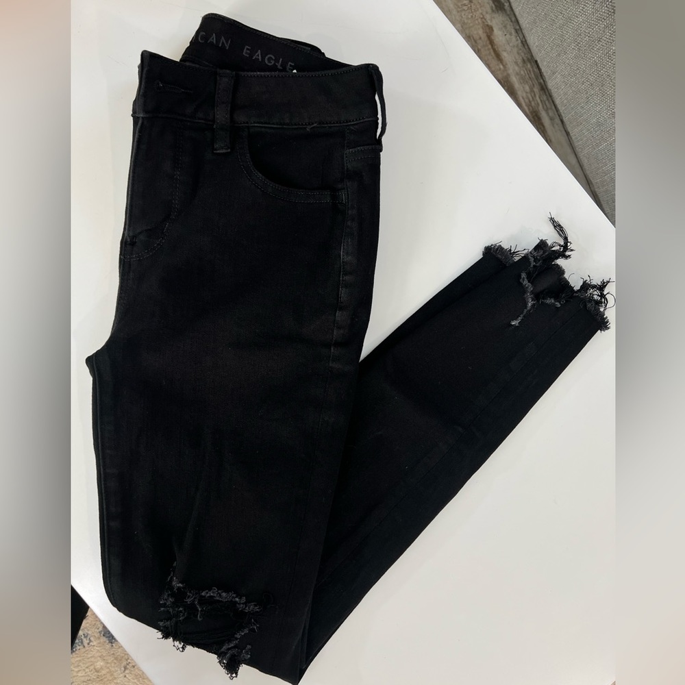 Black distressed American Eagle jean.